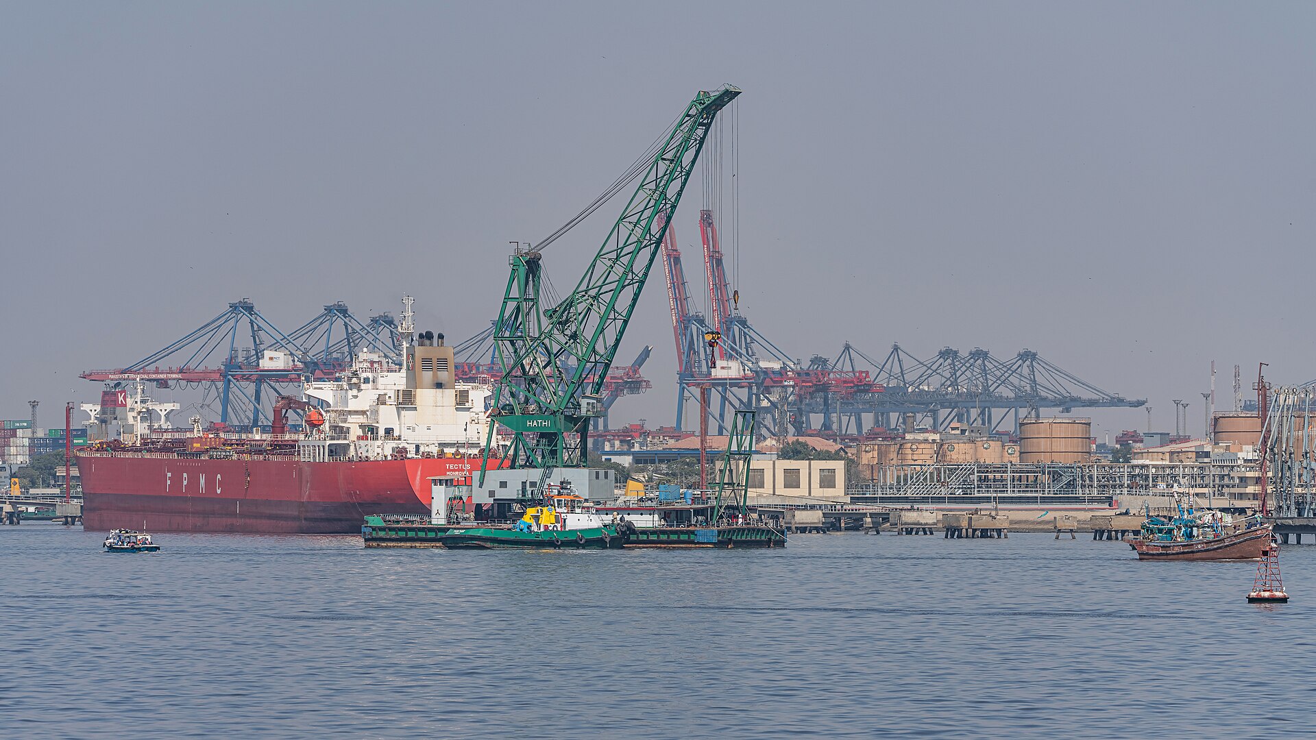 Container cranes and a red cargo ship at the Port of Karachi